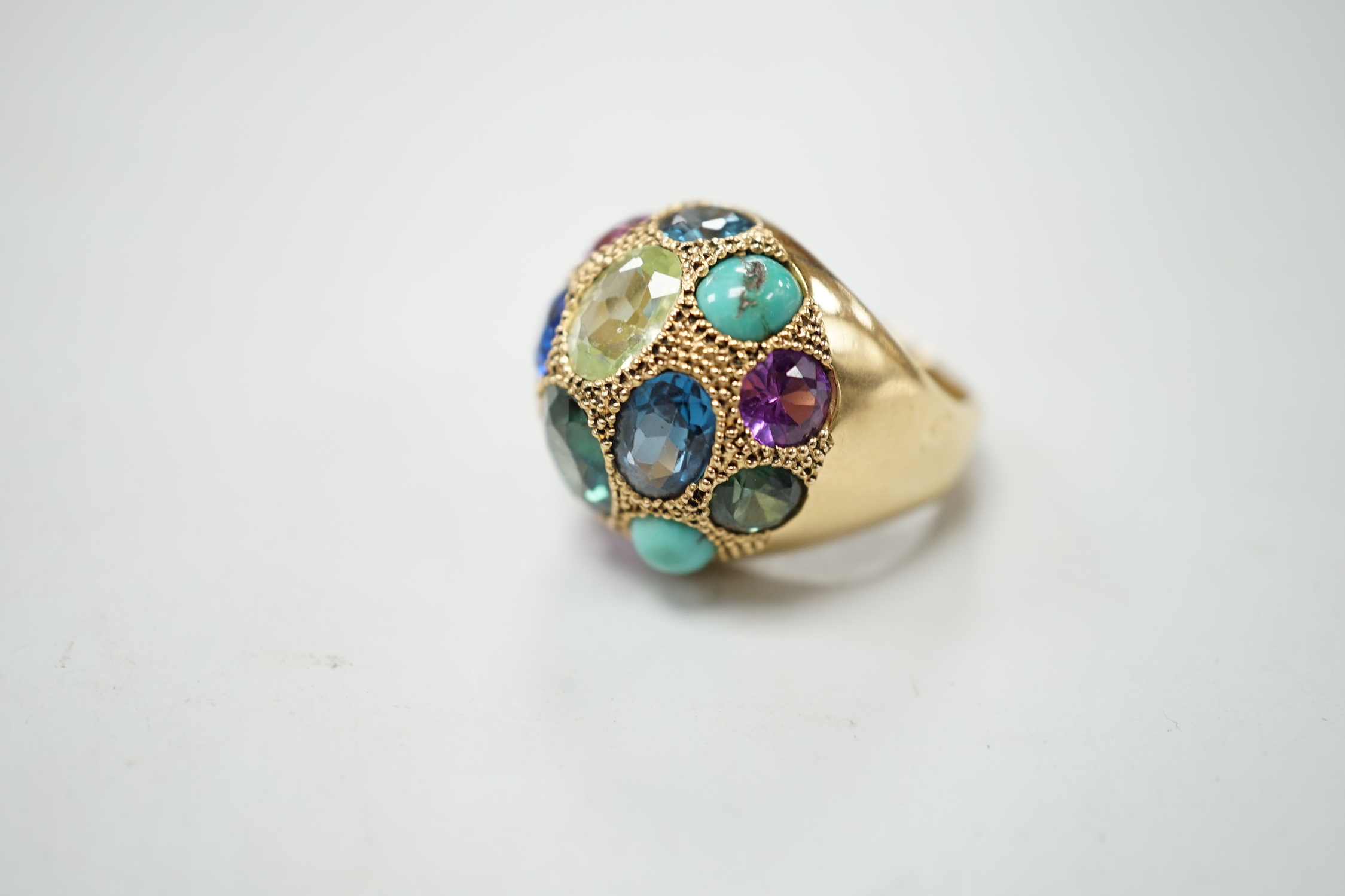 A Middle Eastern yellow metal and multi gem set domed dress ring, size K/L, gross weight 10.5 grams.